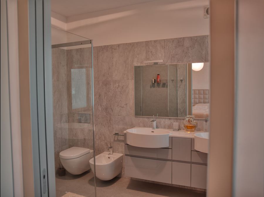 Bathroom with walk-in shower and two basins